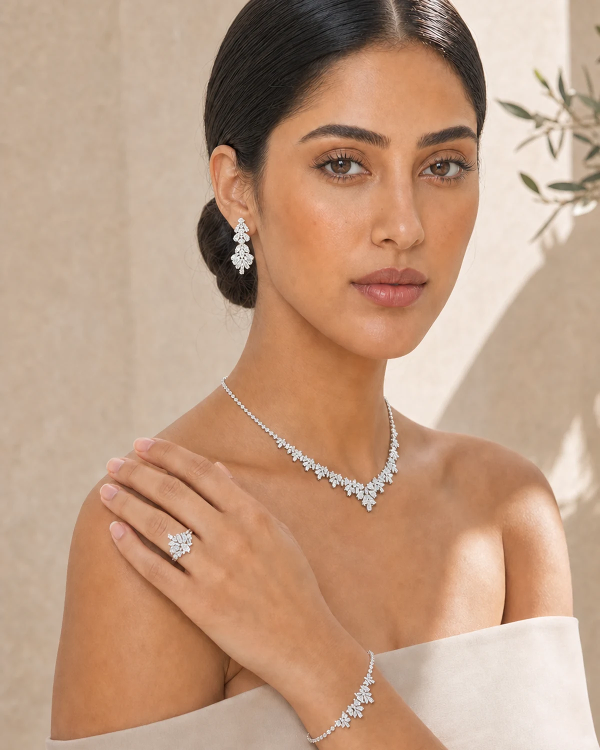 Model wearing the complete Candor jewellery set in warm architectural light.
