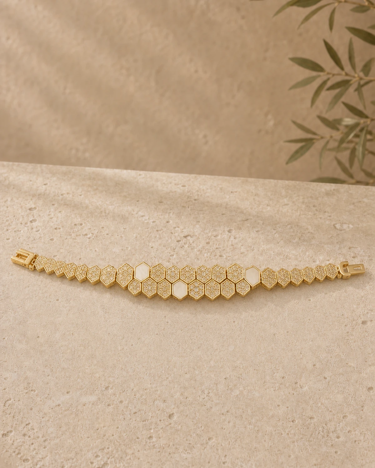 Lucilla's complete articulated geometric link bracelet laid in a gentle curve, showing alternating open and pavé-filled faces, a dense central grouping and both clasp ends.