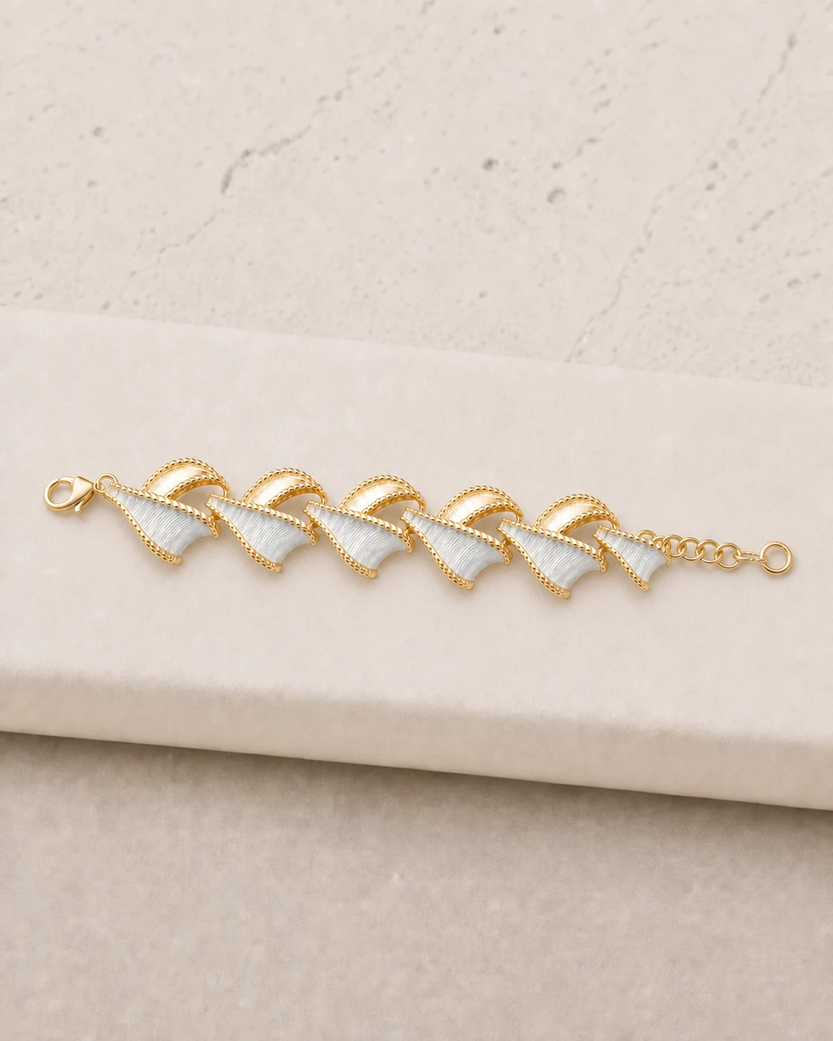 Close product view of the complete short Vesper bracelet with six repeating fan-and-leaf groups between its two closures.